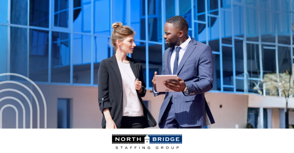 A recruiter works with a job applicant, both speaking over a mobile tablet.