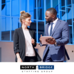 A recruiter works with a job applicant, both speaking over a mobile tablet.