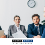 Job applicant sits in front of a panel of interviewers holding a resume